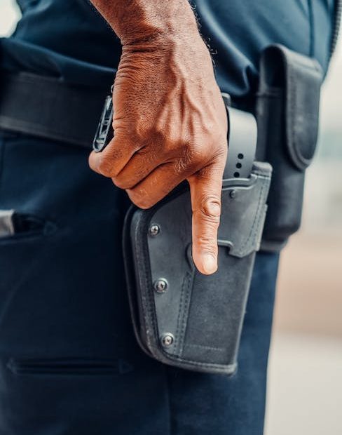 A Policeman Holding his Firearms