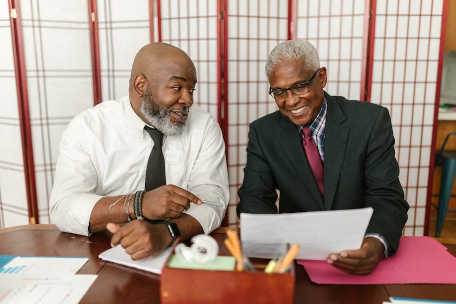 Men in Corporate Attire Smiling while Having Conversation