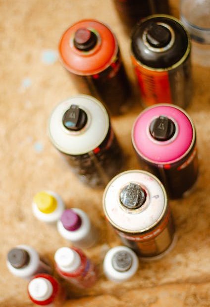 Red and Black Bottles on Brown Wooden Table