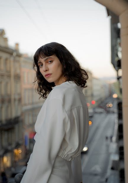 Bohemian Young Woman Standing on Balcony