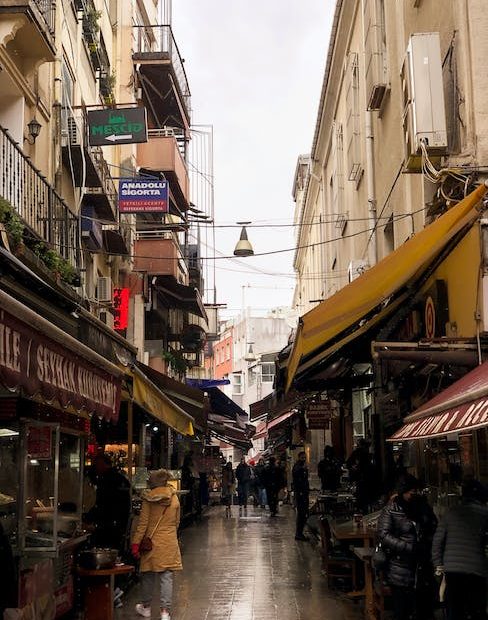 People on Alley in Town after Rain