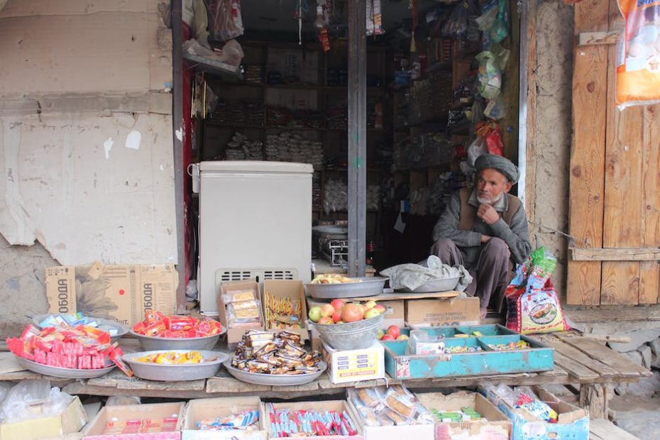 Shop Owner Displaying Goods Outdoors